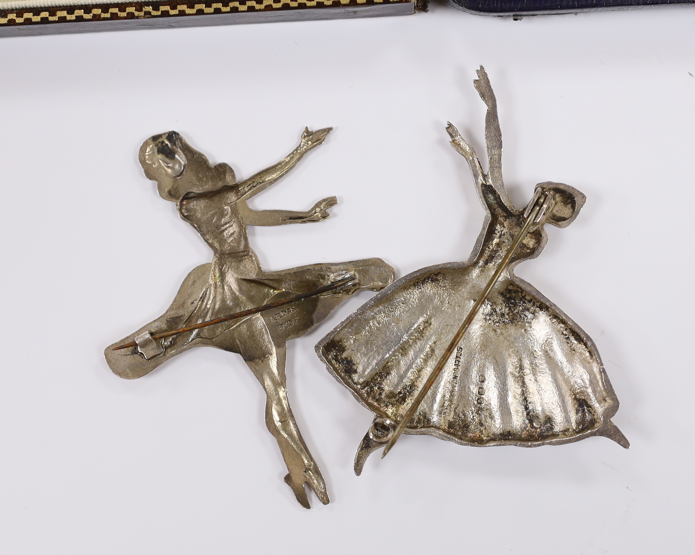 Two silver ballerina brooches, largest 7cm and two cased dress stud set including sterling and mother of pearl.